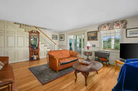 a living room with furniture rug and a window
