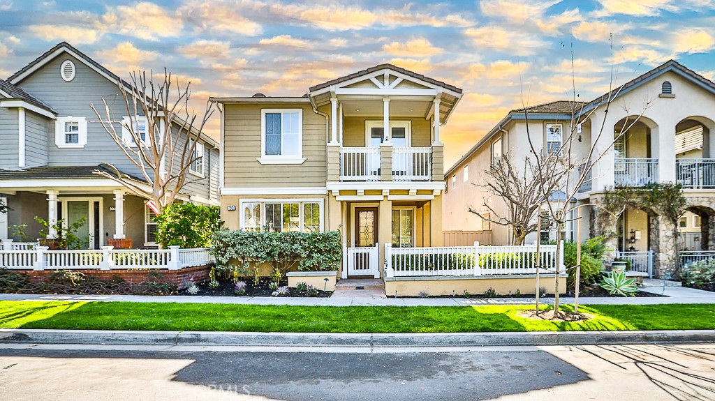a front view of a house with a garden and plants