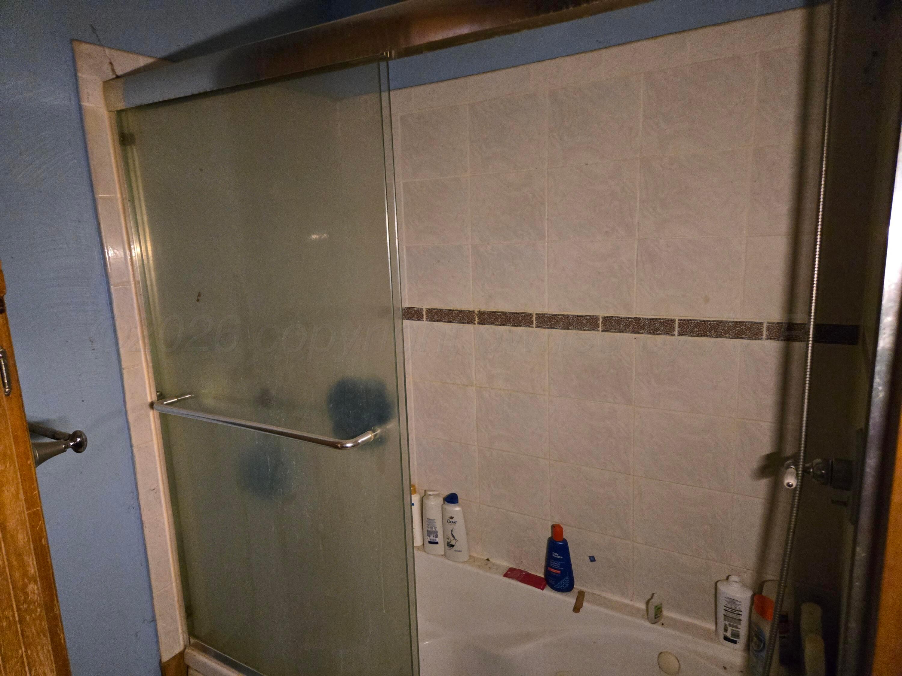 421 North 8th Street Memphis, TX 79245 - Photo 14 of 40 a bathroom with a shower and a toilet