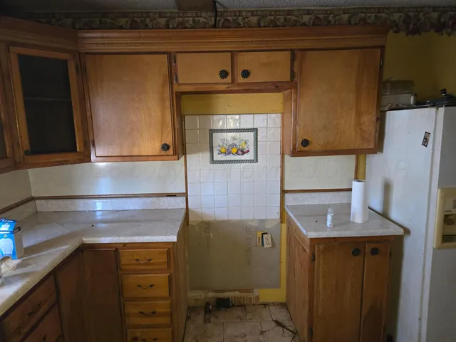 a utility room with multiple dryer and washer