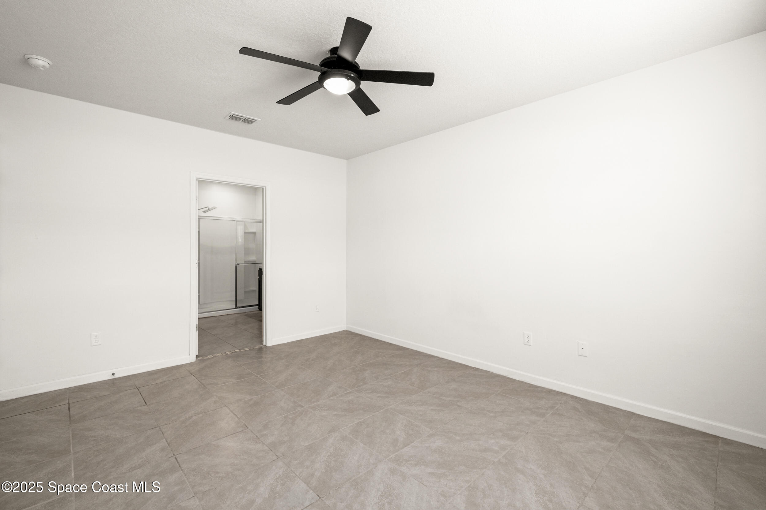 4641 Talbot Boulevard Cocoa, FL 32926 - Photo 11 of 14 a view of a room with a ceiling fan and a ceiling fan