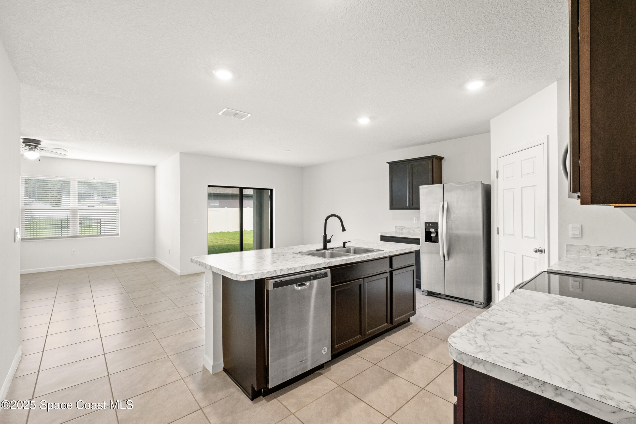 4641 Talbot Boulevard Cocoa, FL 32926 - Photo 2 of 14 a kitchen with stainless steel appliances granite countertop a sink and a refrigerator