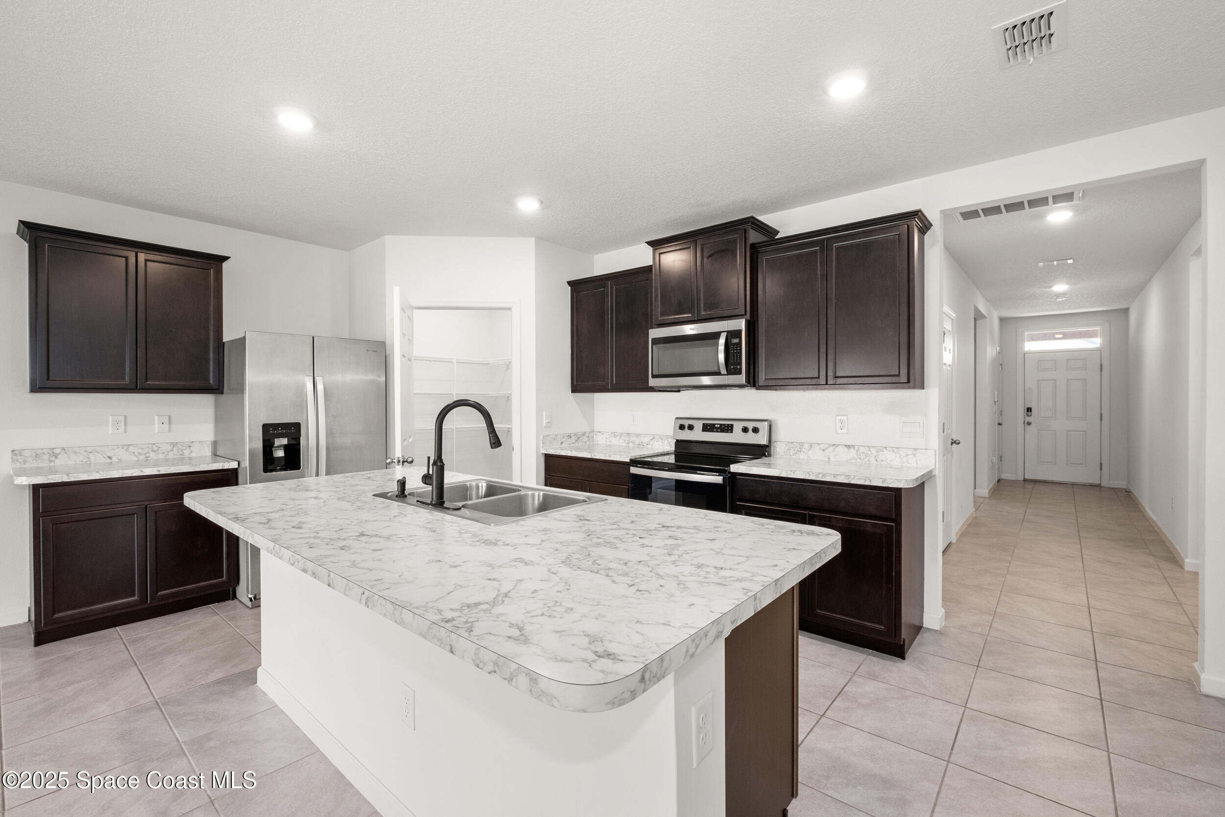4641 Talbot Boulevard Cocoa, FL 32926 - Photo 3 of 14 a kitchen with granite countertop a sink and a stove top oven with wooden floor