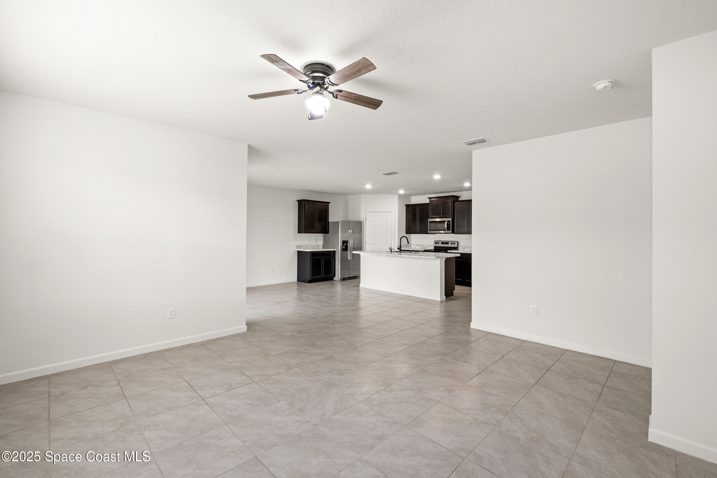 4641 Talbot Boulevard Cocoa, FL 32926 - Photo 5 of 14 a view of a kitchen with a sink and dishwasher a refrigerator with white cabinets