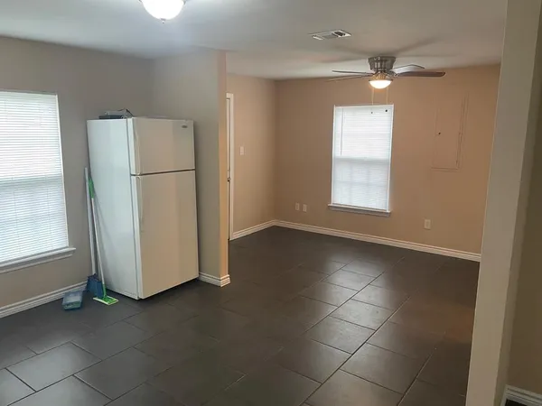 an empty room with windows and closet