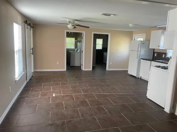 a kitchen with a refrigerator sink and cabinets