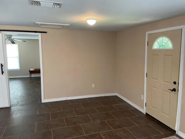 a kitchen with stainless steel appliances granite countertop a sink a refrigerator and a granite counter tops