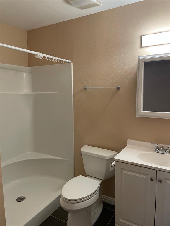 1610 Newsom Mound Road Springtown, TX 76082 - Photo 37 of 40 a white toilet sitting next to a bathroom sink