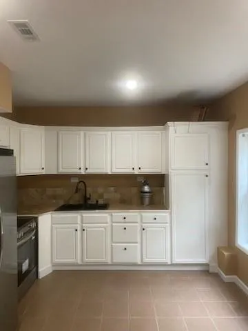 a view of an empty room and a window