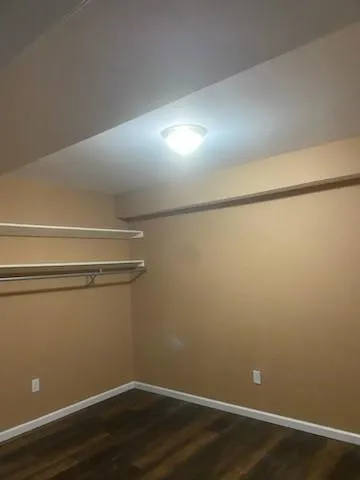 a view of a room with wooden floor