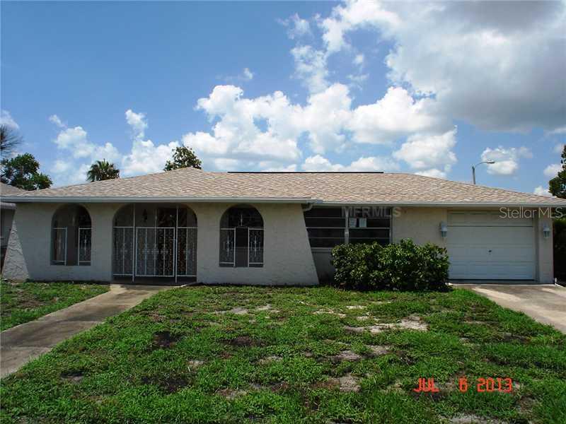 6707 Carnation Way Port Richey, FL 34668 - Photo 1 of 1 a front view of house with yard and green space