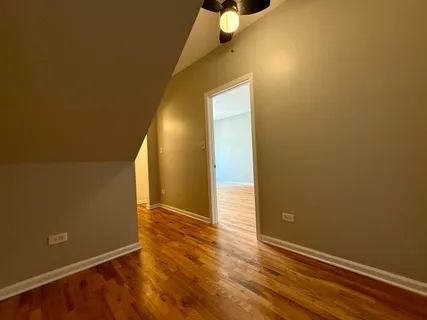 an empty room with wooden floor