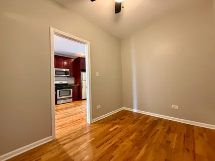 an empty room with wooden floor and closet