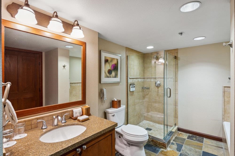 400 Resort Road, Unit 710712 Olympic Valley, CA 96146 - Photo 21 of 28 a bathroom with a sink toilet a mirror and shower