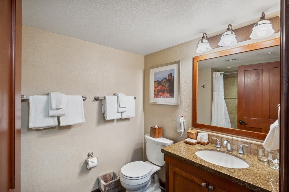 400 Resort Road, Unit 710712 Olympic Valley, CA 96146 - Photo 28 of 28 a bathroom with a granite countertop sink vanity mirror and toilet