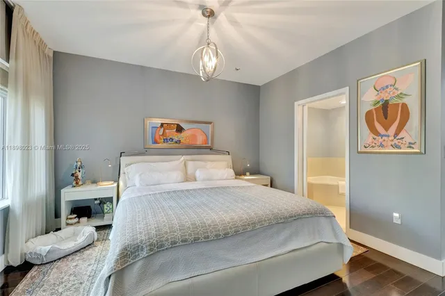 a bedroom with a bed and a chandelier