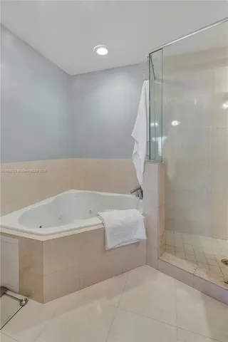 a bathroom with a bathtub and a shower