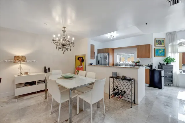 a view of a dining room with furniture and chandelier