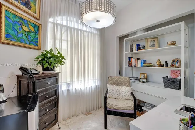 a living room with furniture and a painting on the wall