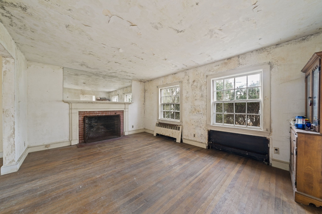 24 Butler Road Hingham, MA 02043 - Photo 11 of 38 a view of an empty room with a window and fireplace