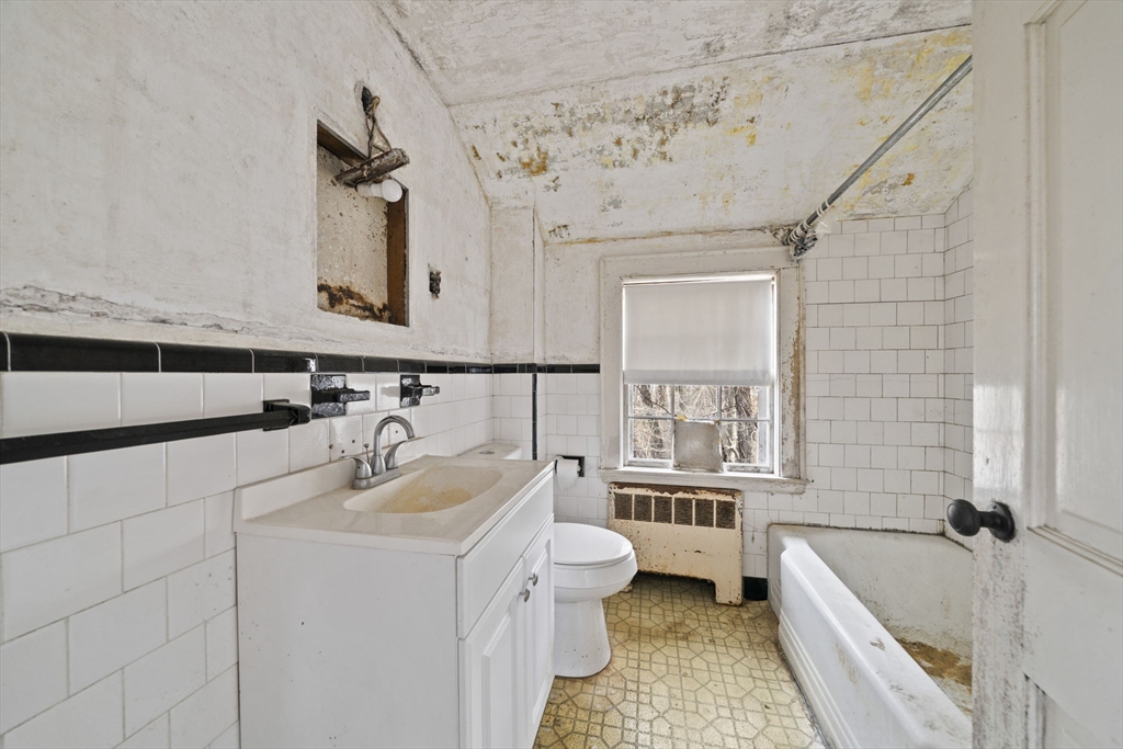 24 Butler Road Hingham, MA 02043 - Photo 20 of 38 a bathroom with a sink a toilet and bathtub