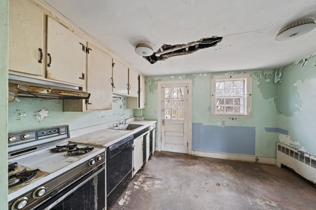 24 Butler Road Hingham, MA 02043 - Photo 3 of 38 a kitchen with a stove and a refrigerator