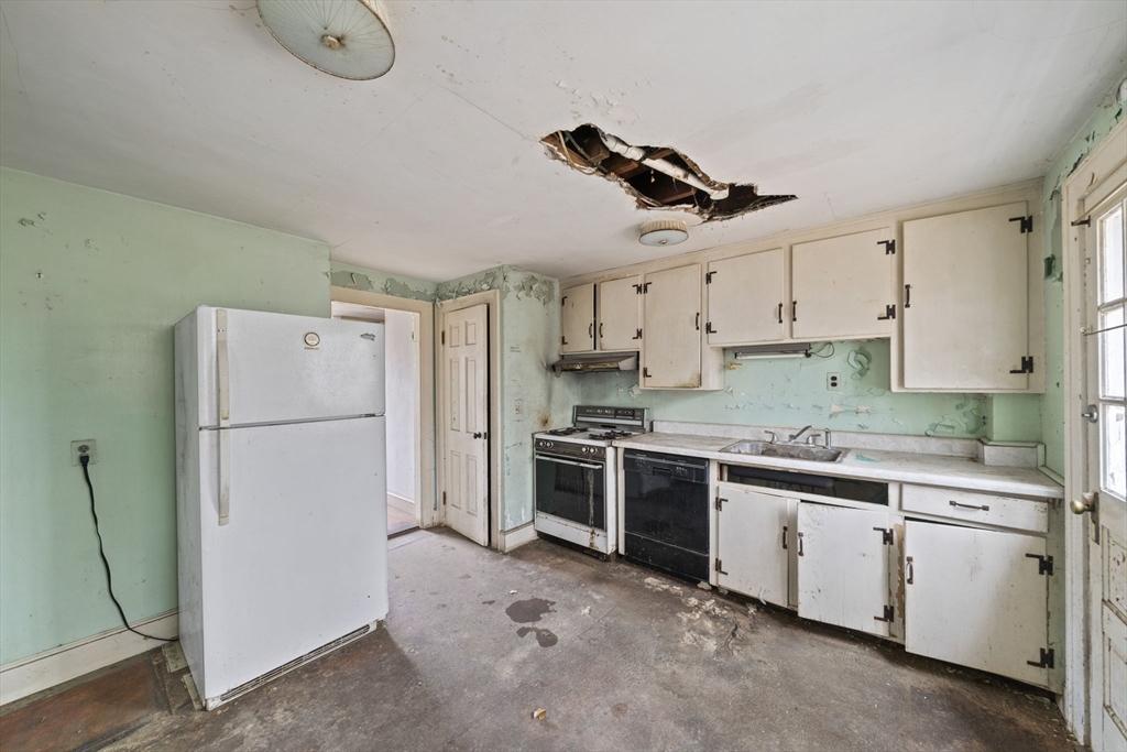 24 Butler Road Hingham, MA 02043 - Photo 5 of 38 a kitchen with a white cabinets and white appliances