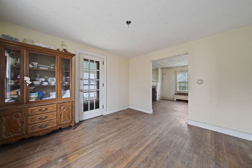 24 Butler Road Hingham, MA 02043 - Photo 6 of 38 a view of an empty room with window and wooden floor