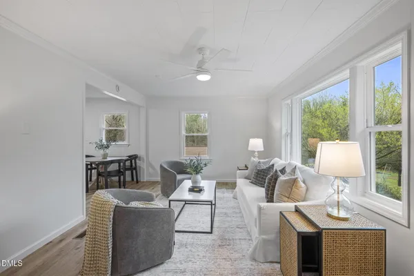 a living room with furniture a table and a lamp