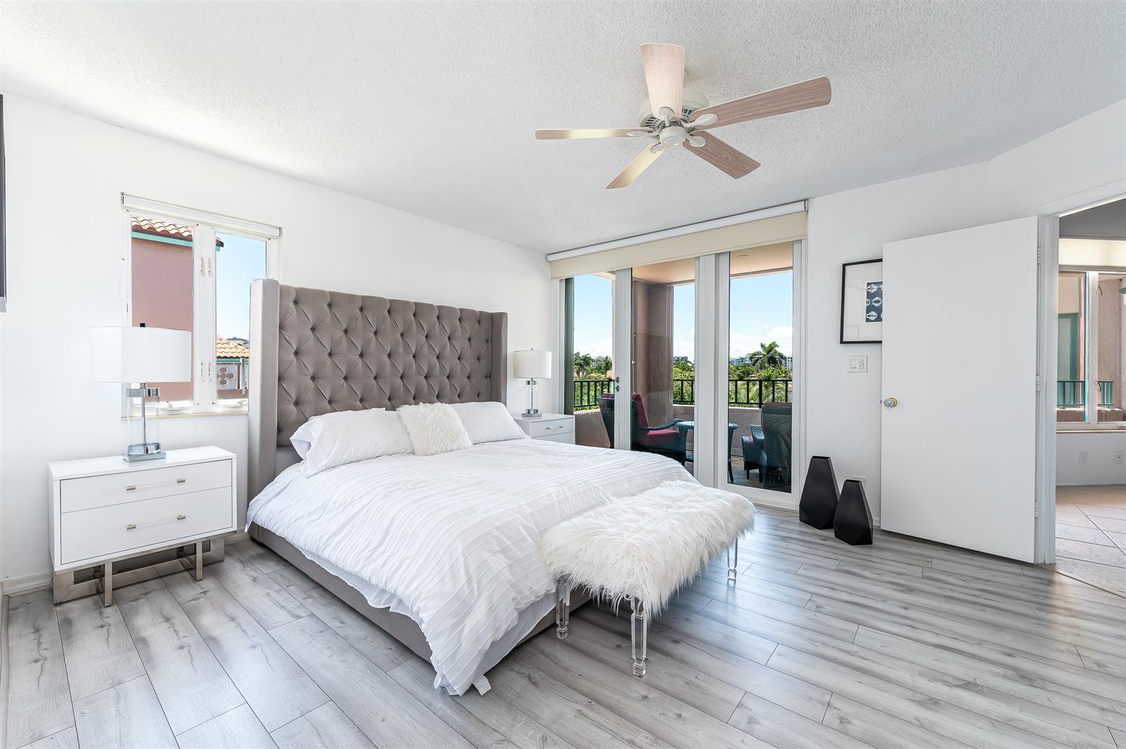120 Southeast 5th Avenue, Unit PH22 Boca Raton, FL 33432 - Photo 11 of 32 a bedroom with a bed and a chandelier