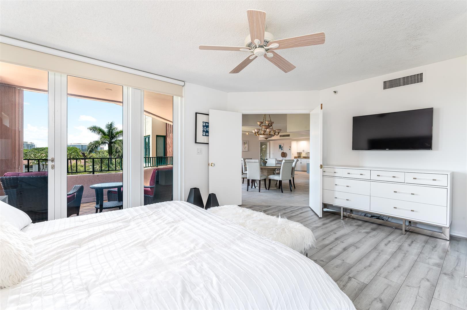 120 Southeast 5th Avenue, Unit PH22 Boca Raton, FL 33432 - Photo 12 of 32 a bedroom with furniture and flat screen tv