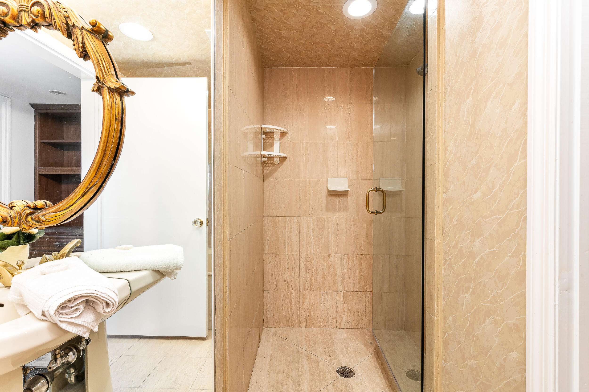 120 Southeast 5th Avenue, Unit PH22 Boca Raton, FL 33432 - Photo 13 of 32 a bathroom with a sink and a mirror