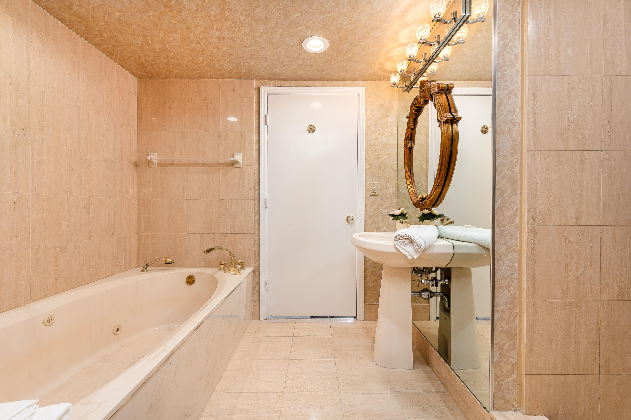 120 Southeast 5th Avenue, Unit PH22 Boca Raton, FL 33432 - Photo 14 of 32 a bathroom with a bathtub and a sink