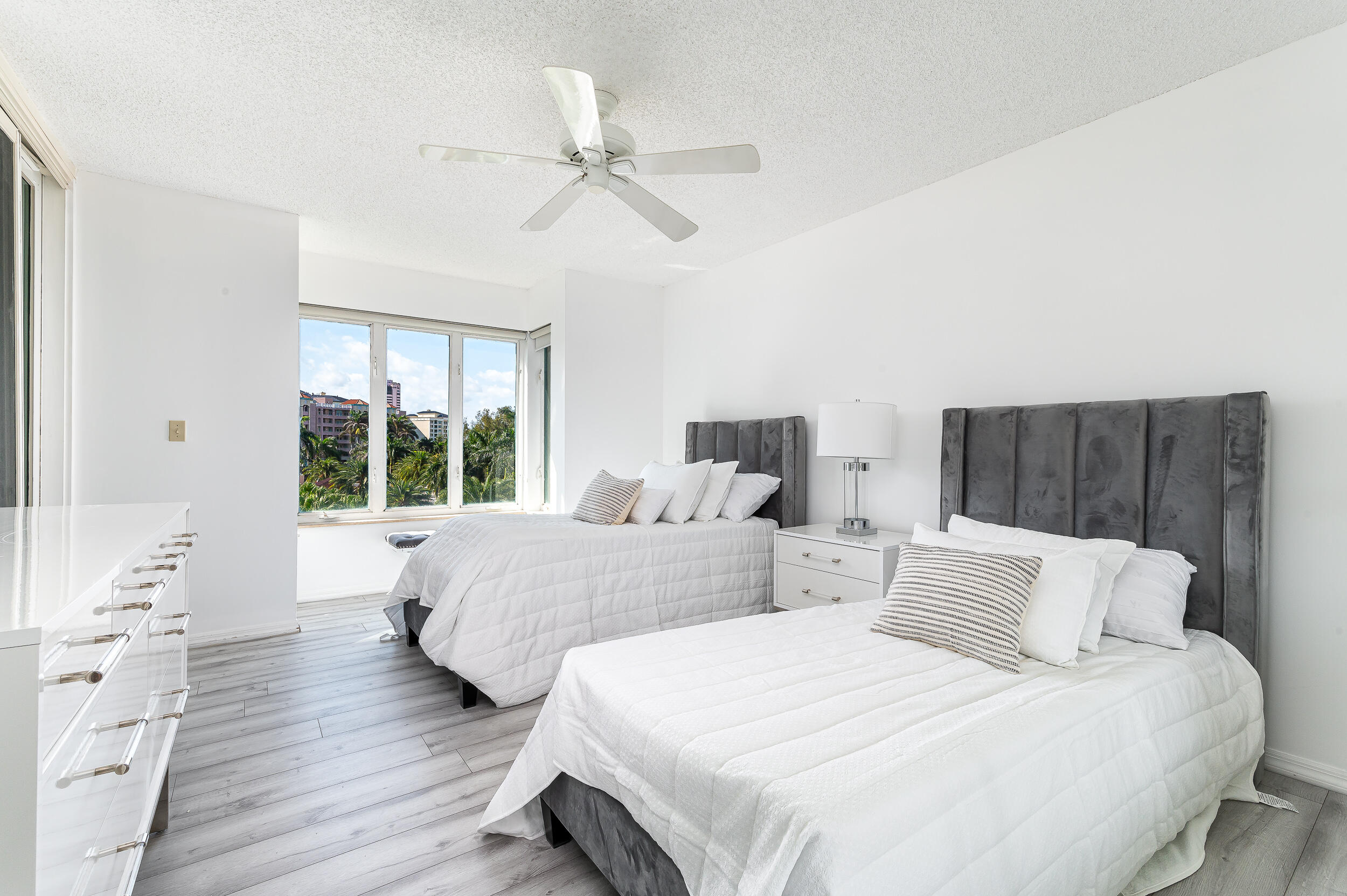 120 Southeast 5th Avenue, Unit PH22 Boca Raton, FL 33432 - Photo 17 of 32 a bedroom with two beds and a large window