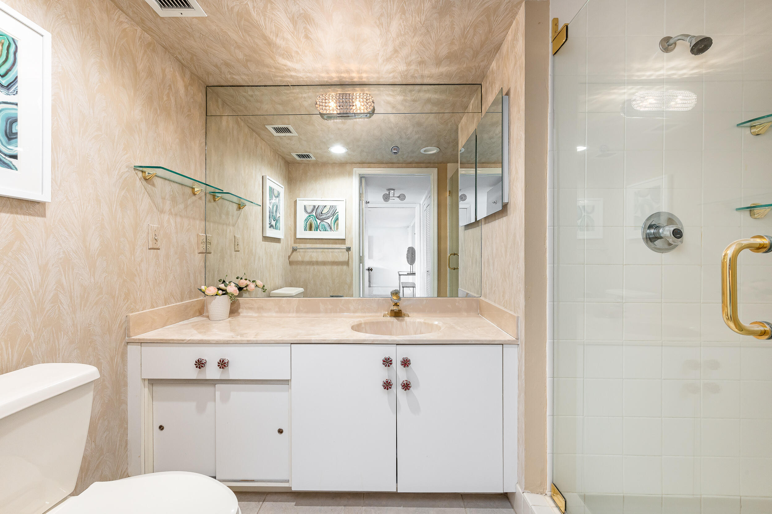 120 Southeast 5th Avenue, Unit PH22 Boca Raton, FL 33432 - Photo 18 of 32 a bathroom with a double vanity sink toilet mirror and shower