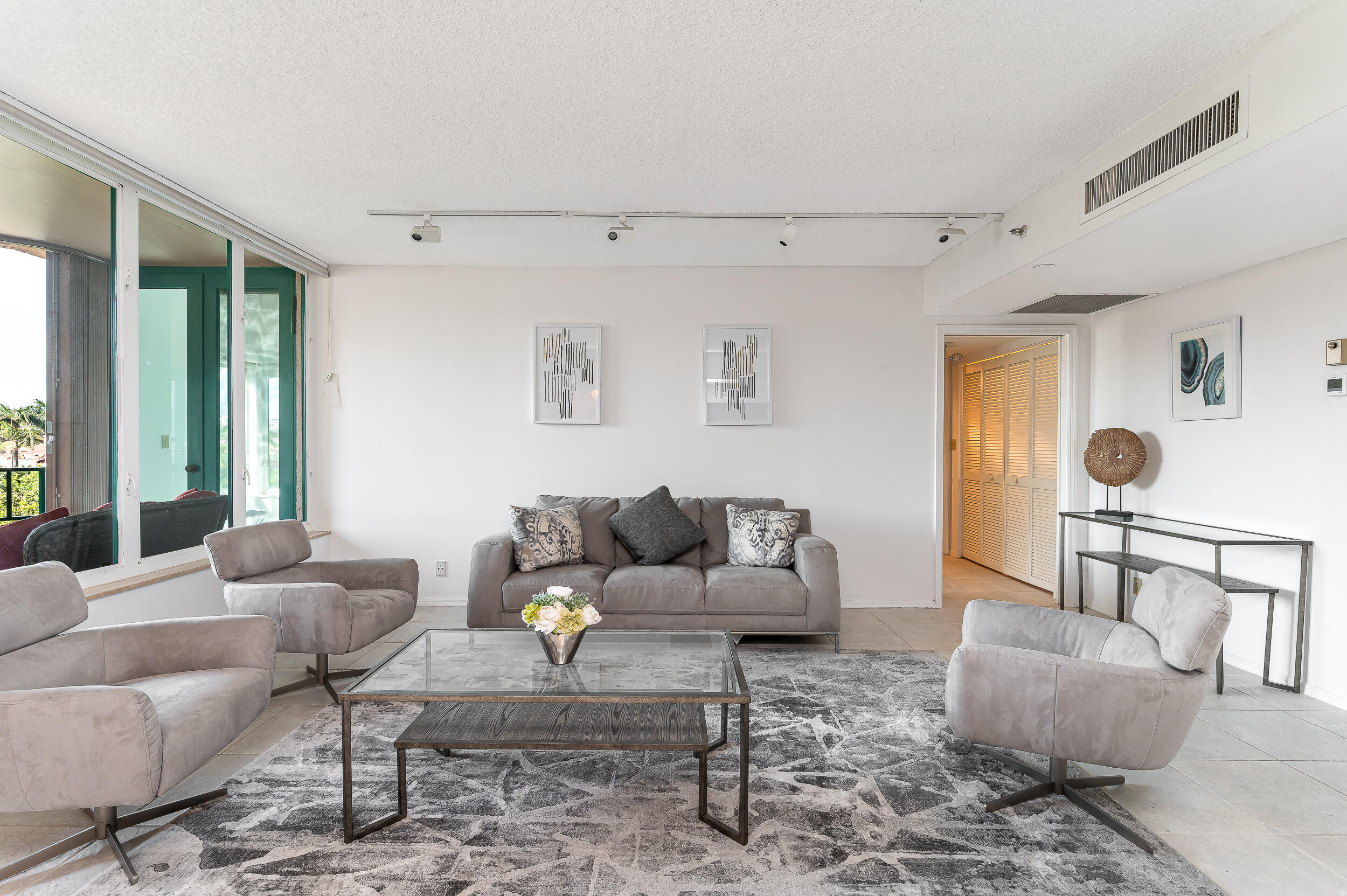 120 Southeast 5th Avenue, Unit PH22 Boca Raton, FL 33432 - Photo 2 of 32 a living room with furniture and a large window