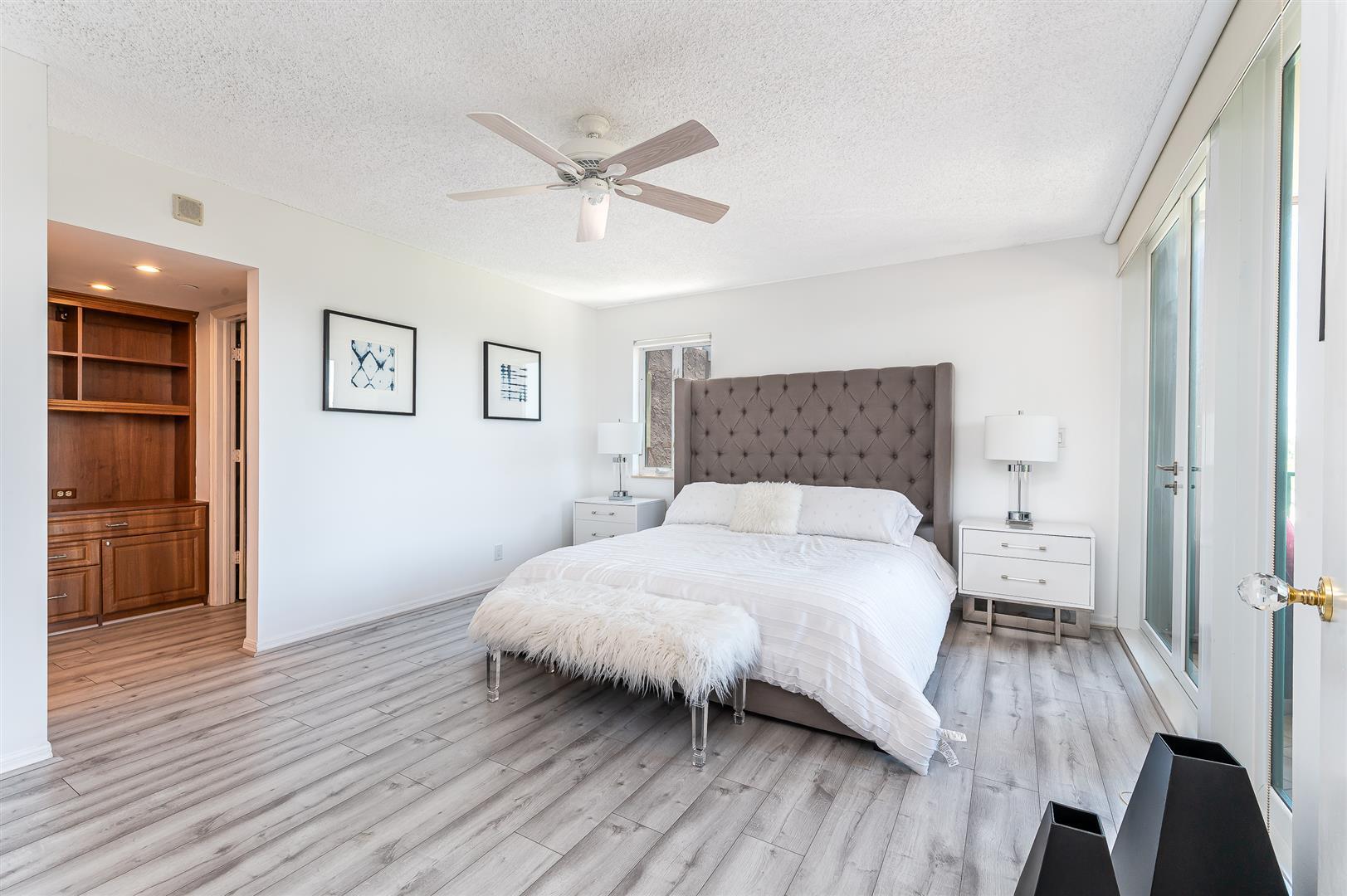 120 Southeast 5th Avenue, Unit PH22 Boca Raton, FL 33432 - Photo 9 of 32 a bedroom with a bed and wooden floor