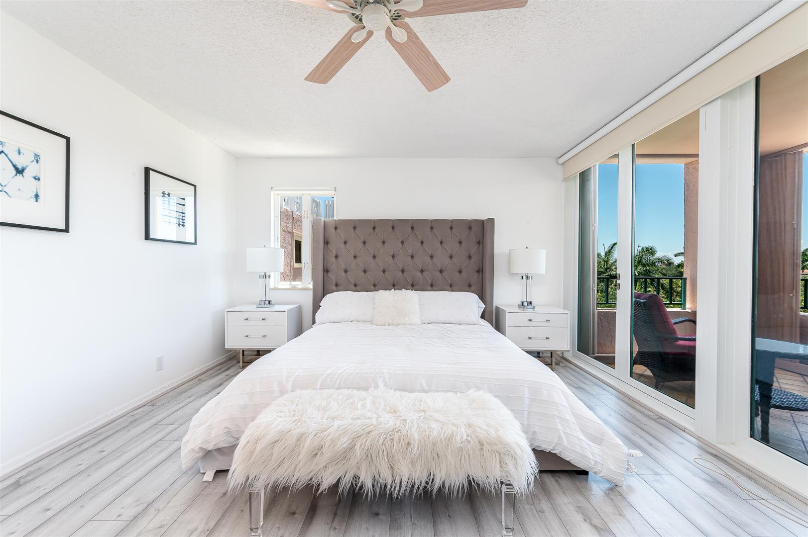 120 Southeast 5th Avenue, Unit PH22 Boca Raton, FL 33432 - Photo 10 of 32 a bedroom with a bed and a large window