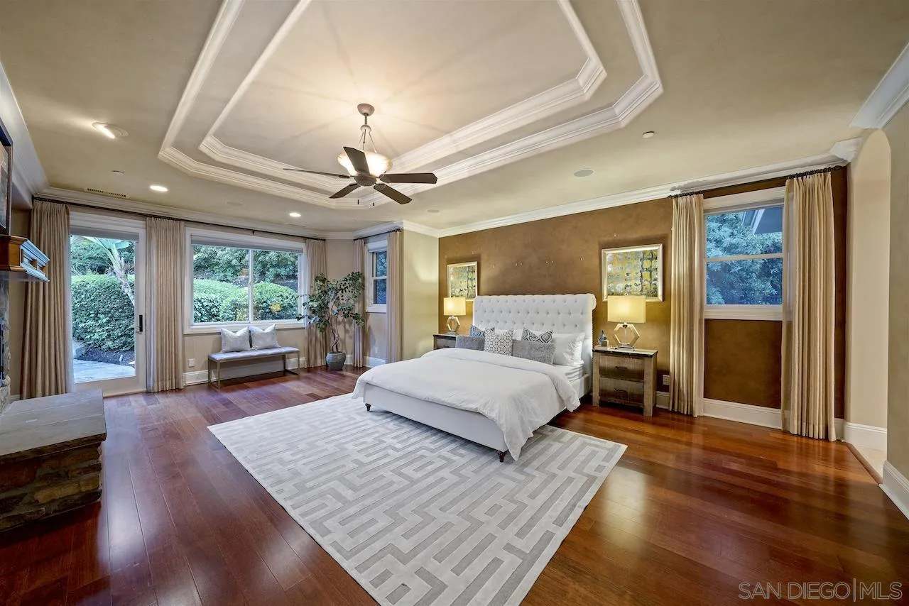16644 Valle Verde Road Poway, CA 92064 - Photo 23 of 37 a spacious bedroom with a large bed and a chandelier