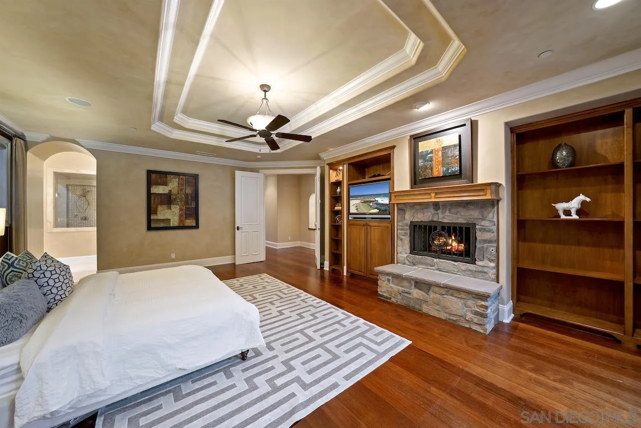 16644 Valle Verde Road Poway, CA 92064 - Photo 24 of 37 a spacious bedroom with a bed and a fireplace