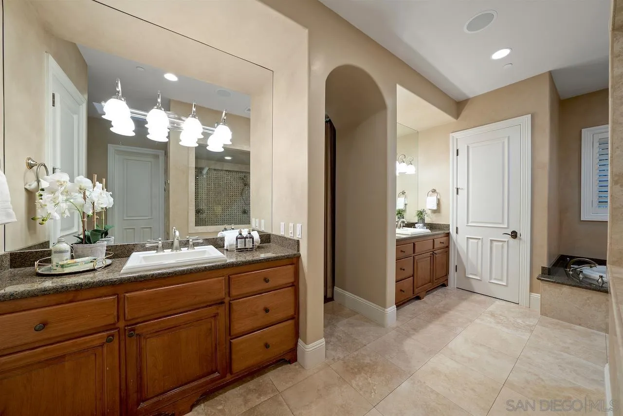 16644 Valle Verde Road Poway, CA 92064 - Photo 25 of 37 a spacious bathroom with a double vanity sink a mirror and a shower