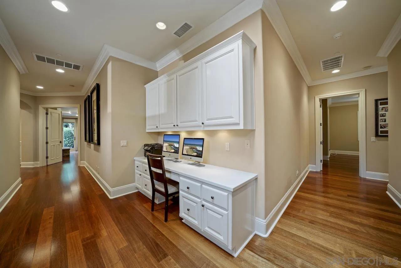 16644 Valle Verde Road Poway, CA 92064 - Photo 30 of 37 a kitchen with white cabinets and wooden floor