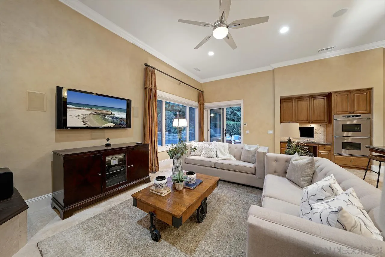 16644 Valle Verde Road Poway, CA 92064 - Photo 5 of 37 a living room with furniture a flat screen tv and a fireplace