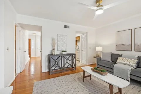 a living room with furniture and a wooden floor