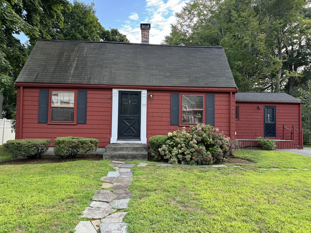 107 Valley Road Needham, MA 02492 - Photo 1 of 2 a front view of a house with garden