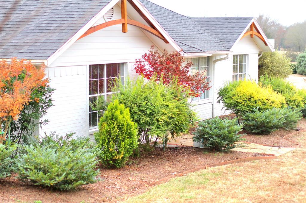 White residential exterior with multiple gables and a dark shingle roof