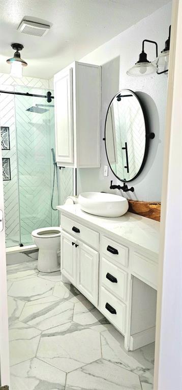 301 County Road Blossom, TX 75416 - Photo 11 of 19 Bathroom featuring a white vanity with black hardware, a vessel sink, and a wall-mounted faucet