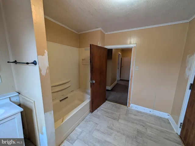 a bathroom with a tub and shower