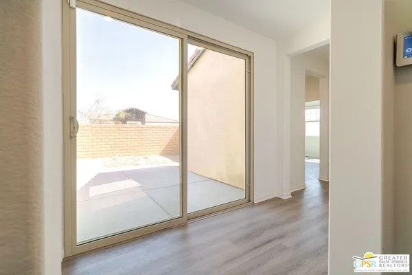 a living room with furniture and a dining table with wooden floor