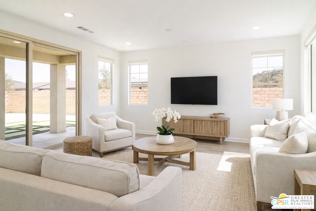 78924 Santa Rosa Way Palm Desert, CA 92211 - Photo 19 of 71 a living room with furniture a flat screen tv and a large window